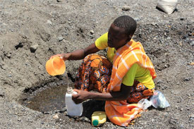 Digging for drinking water in a dry riverbed. Photo provided by 'Marisol Grandon/Department for International Development.'