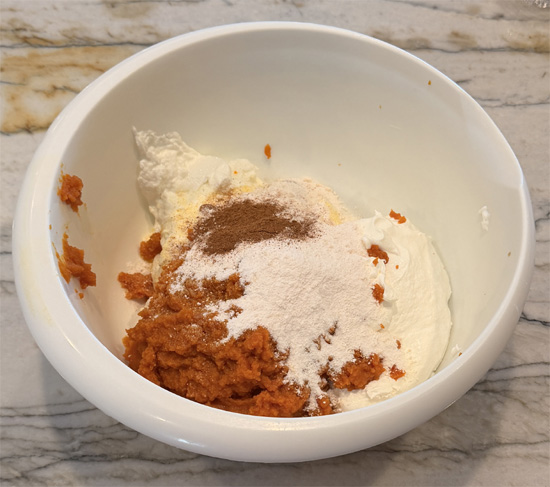 In a large bowl, stir together the yogurt, pumpkin, whipped topping, pudding mix, pumpkin pie spice, and caramel syrup until smooth and completely combined, with no streaks of whipped topping left.
