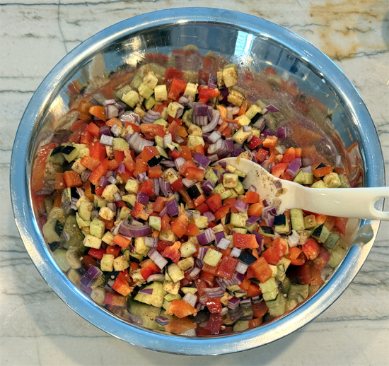 Mix the olive oil, garlic, pepper and salt in with the vegetables. Toss until coated.