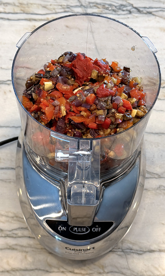 Transfer the vegetables to a food processor. Add the tomato paste and vinegar then pulse until blended. (The mixture should be chunky.)