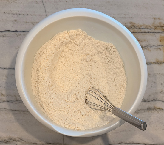 In a large bowl, whisk together the cake mix and protein powder. 
