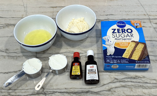 In a large bowl, use a mixer to combine the cake mix, protein powder, 2 egg whites, yogurt, vanilla extract and butter extract.