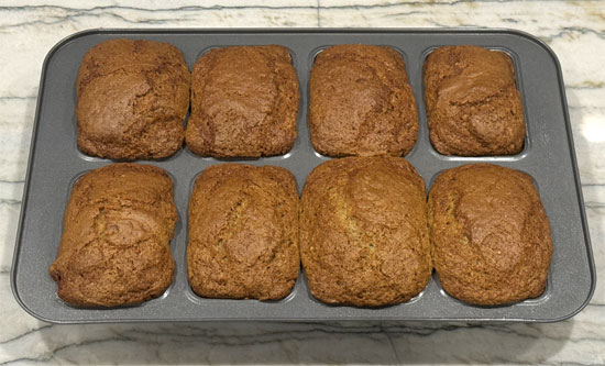 Let the loaves cool for 5 minutes; they should then be easy to remove from the pan. Add a little butter to each one for a nice finish. 