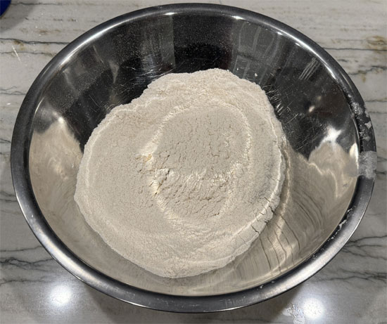In a large mixing bowl, thoroughly combine the first nine dry ingredients, flour through allspice.