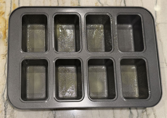 Lightly spray 12 trays of two 8-mini-loaf baking pans with buttery cooking spray.