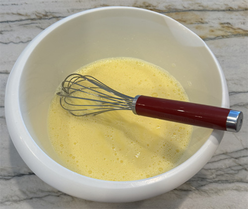 In a separate mixing bowl, whisk together the milk and eggs.
