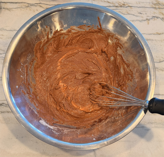 Mix together the cake mix, 2.1 oz of chocolate pudding mix, protein powder, 2 cups of milk, and egg whites until combined.