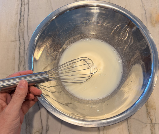 Mix together the 1 1/4 cups of cold milk and almond extract. 