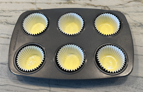 Lightly coat 6 jumbo baking cups (cupcake liners) with buttery spray. Place them in a 6-cup muffin tin.