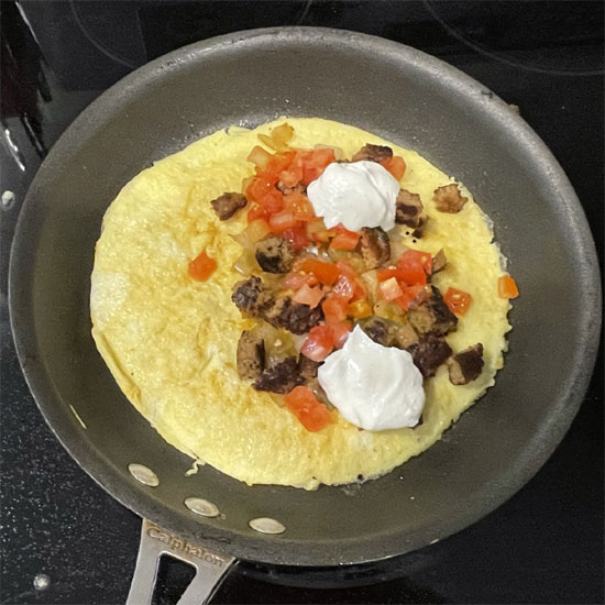 Egg and Meatless Sausage Burrito - Adding Sour Cream