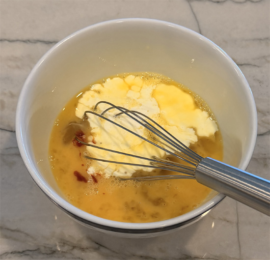 In a small bowl, whisk together the whole egg, egg whites, heavy cream, and gochujang until smooth.