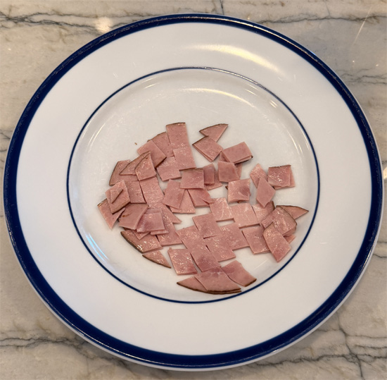 Cut the ham into small pieces and slice the green onions; set both aside.