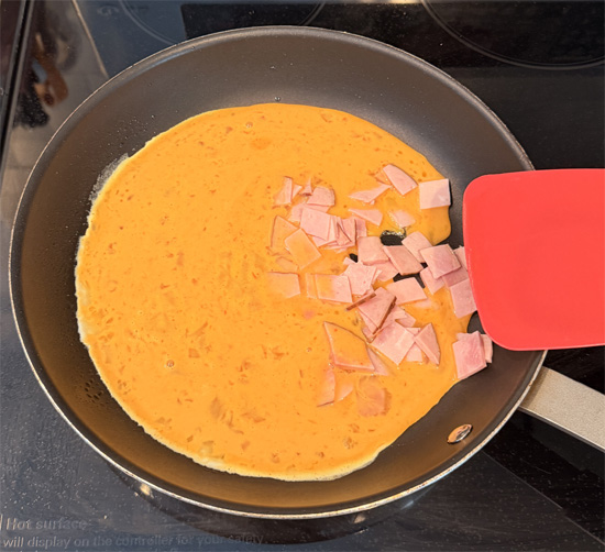 Add the ham and egg mixture to the pan. Cook over medium heat, gently stirring and scraping the bottom, until the eggs are softly scrambled and just set.