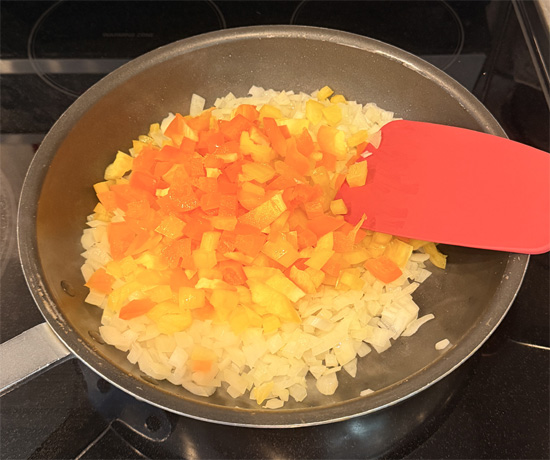 Cook the onion for 2 minutes, then add the bell peppers and cook another 2 minutes. Add the mushrooms and continue cooking until the onion is soft and translucent, about 3 more minutes.