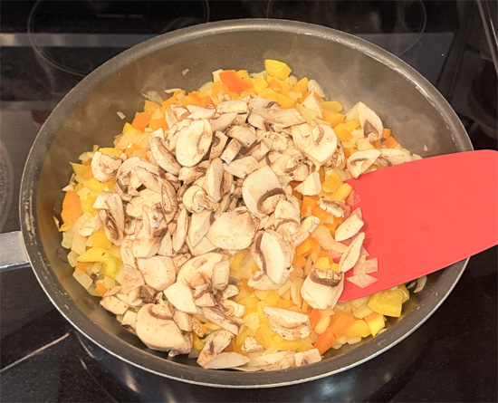 Cook the onion for 2 minutes, then add the bell peppers and cook another 2 minutes. Add the mushrooms and continue cooking until the onion is soft and translucent, about 3 more minutes.