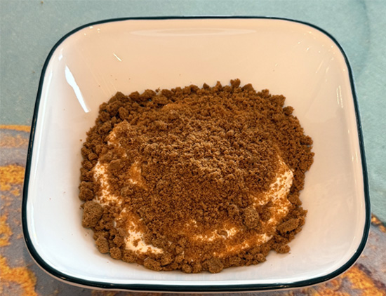Crush the Biscoff cookies, then divide that between the two bowls. 