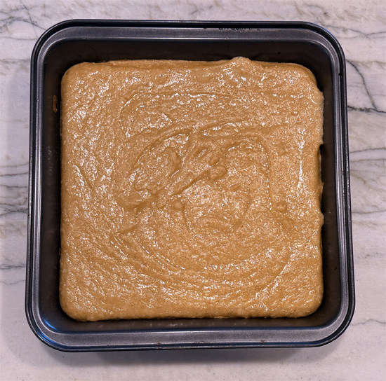 Bake for 15 minutes, then take the pan out and sprinkle the remaining 2 tablespoons of white chocolate chips over the top. The chips go on late so they don't scorch before the center sets.