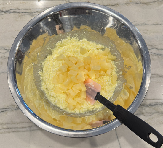 Fold in drained pineapple tidbits.