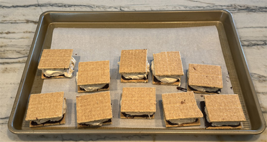 Top each with a plain cracker half to create sandwiches.