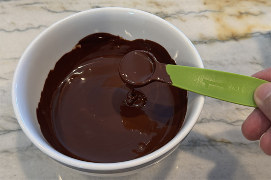 Combine chocolate chips and coconut oil in a microwave-safe bowl. Microwave in 20-second intervals, stirring between each interval, until completely melted (about 60 seconds total).