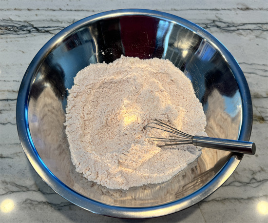Mix the dry ingredients: In a large bowl, whisk together your cake mix, sugar-free Jell-O powder (orange or raspberry), and protein powder until well combined and evenly colored.