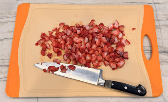 Spread half the fruit you chose over one pan and the other half over the second pan.