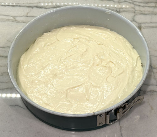 Pour the cheesecake over the top of the graham cracker crust.