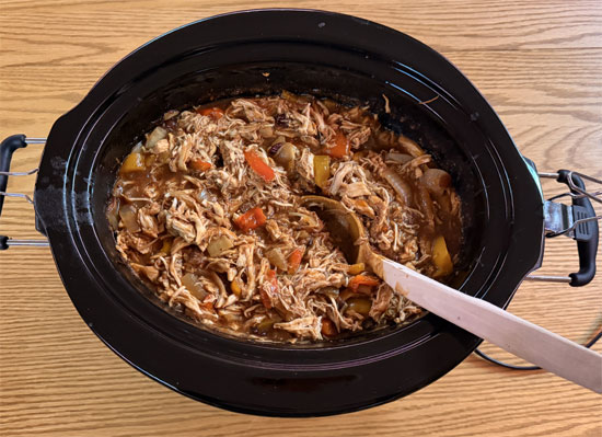 While quinoa is cooking, remove chicken from slow cooker and shred with two forks. Return shredded chicken to pot and stir into sauce.