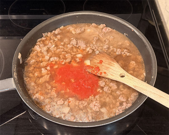 Pour in the beef broth, tomato sauce, and water. Increase heat to high and bring to a boil, stirring occasionally.
