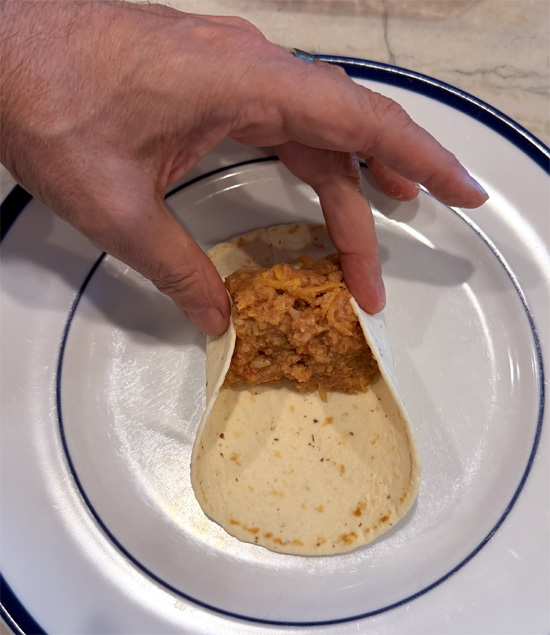 Spoon about 1/3 cup of filling onto each tortilla. Fold in the sides, then roll up tightly.