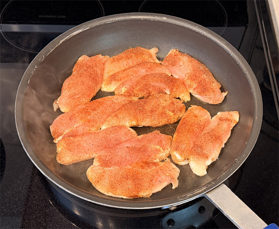 Lightly spray the pan with olive oil. Put the chicken in spice side down, then sprinkle the rest of the spice mixture over the top. Cook 5 minutes, flip, and cook 5 minutes more. The chicken is done when the middle reaches 165 degrees Fahrenheit.