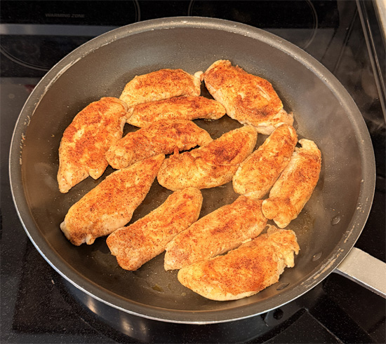Lightly spray the pan with olive oil. Put the chicken in spice side down, then sprinkle the rest of the spice mixture over the top. Cook 5 minutes, flip, and cook 5 minutes more. The chicken is done when the middle reaches 165 degrees Fahrenheit.