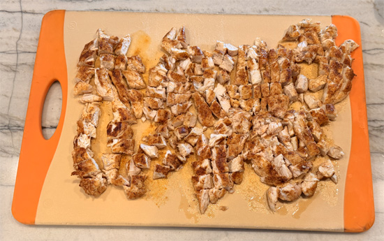 Take the chicken out of the pan and cut it into bite sized pieces. Set it aside.