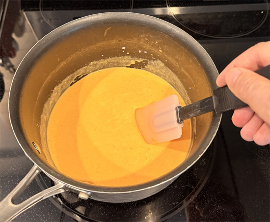 Stir in the Frank's sauce and the diced jalapeño. Keep mixing until it's fully combined.