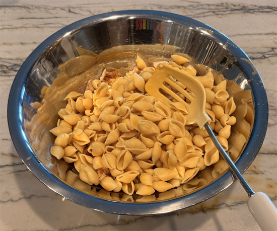 Combine the chicken and pasta in a large bowl, pour the cheese sauce over the top, and mix until everything is coated.