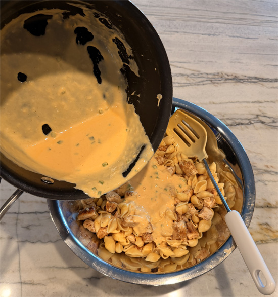 Combine the chicken and pasta in a large bowl, pour the cheese sauce over the top, and mix until everything is coated.
