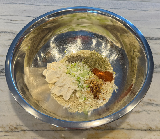 Prepare the Meatball Mixture: In a large bowl, combine the panko bread crumbs, yogurt, garlic, scallions, oregano, crushed red pepper, paprika, black pepper, and salt. Whisk the eggs together and put them in the mix. Add the ground chicken and mix until fully combined.