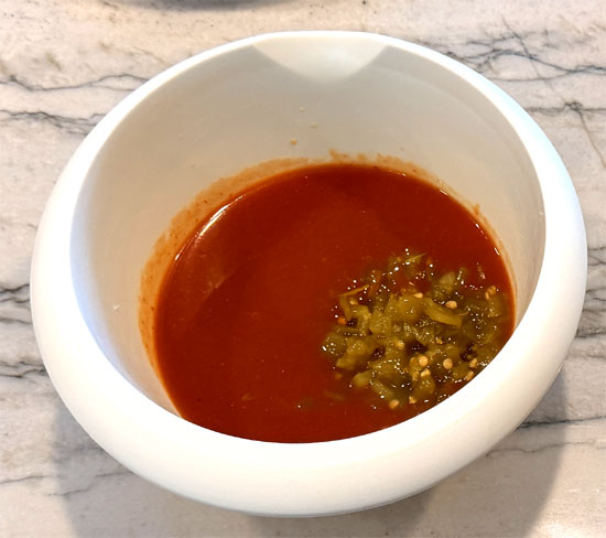 In a small bowl, mix together the enchilada sauce and green chiles. 