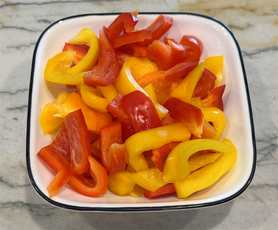 Prep vegetables: Slice onion and bell peppers, chop mint. Set aside.