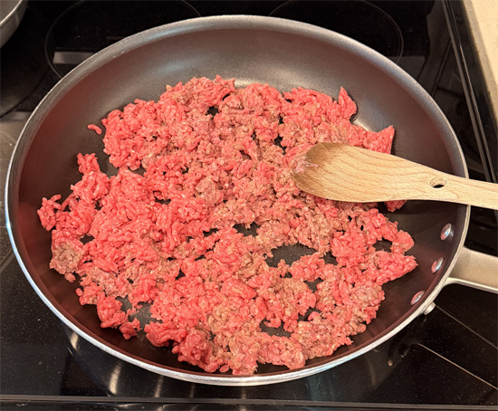 Heat a large skillet (at least 14 inches across) over medium-high heat. Add ground beef and cook just until no longer pink, breaking it up while cooking. 