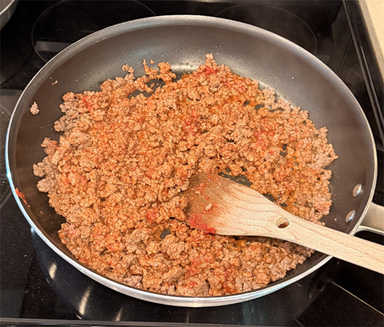 As soon as the beef is no longer pink (but not yet browned), stir in the tomato paste. Add the halved tomatoes and cook until the tomatoes start to fall apart and beef browns, about 5 more minutes. 