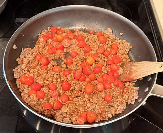 As soon as the beef is no longer pink (but not yet browned), stir in the tomato paste. Add the halved tomatoes and cook until the tomatoes start to fall apart and beef browns, about 5 more minutes. 