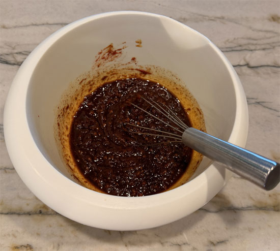 In a medium bowl, mix together salt, pepper, Baharat spice, paprika, olive oil, tomato paste, date syrup, and garlic. 