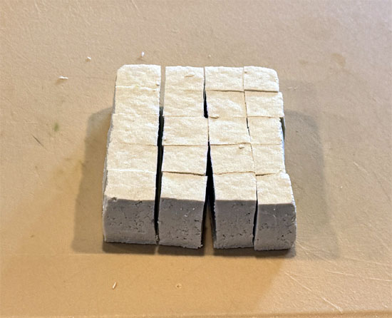 After pressing the tofu, cut it into 3/4-inch cubes. This includes cutting the block in half, so you will have about 40 cubes.