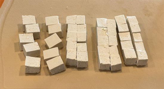 After pressing the tofu, cut it into 3/4-inch cubes. This includes cutting the block in half, so you will have about 40 cubes.
