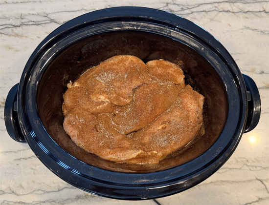 Sprinkle half the seasoning over the chicken, flip the breasts, then sprinkle the remaining seasoning on the other side.