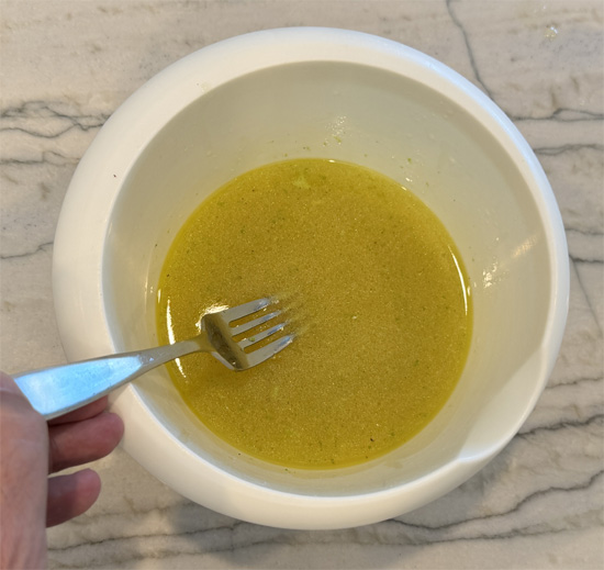 In a small bowl, whisk together chicken broth, lime juice, lime zest, olive oil, and minced garlic.