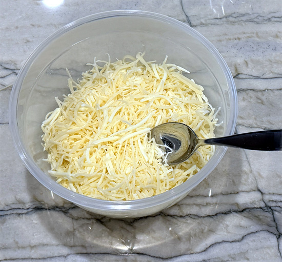 In another bowl, combine both mozzarella cheeses and Parmesan. Set aside.