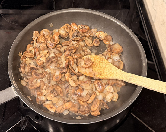 Stir until sizzling, then reduce heat to medium-low. Cook, stirring occasionally, until onions are soft and lightly golden, about 8-10 minutes. Set aside.