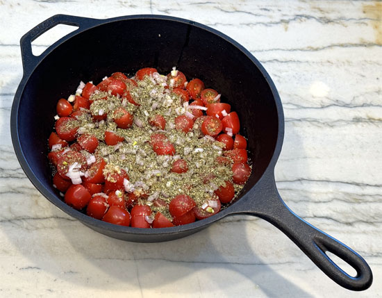 In an oven-safe baking dish, combine tomatoes, shallots, garlic, salt, feta cheese, olive oil, and Italian seasoning. Mix well.
